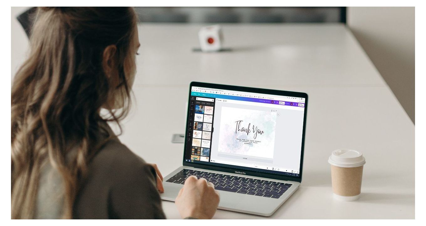 Woman working in Canva editor on a laptop. 