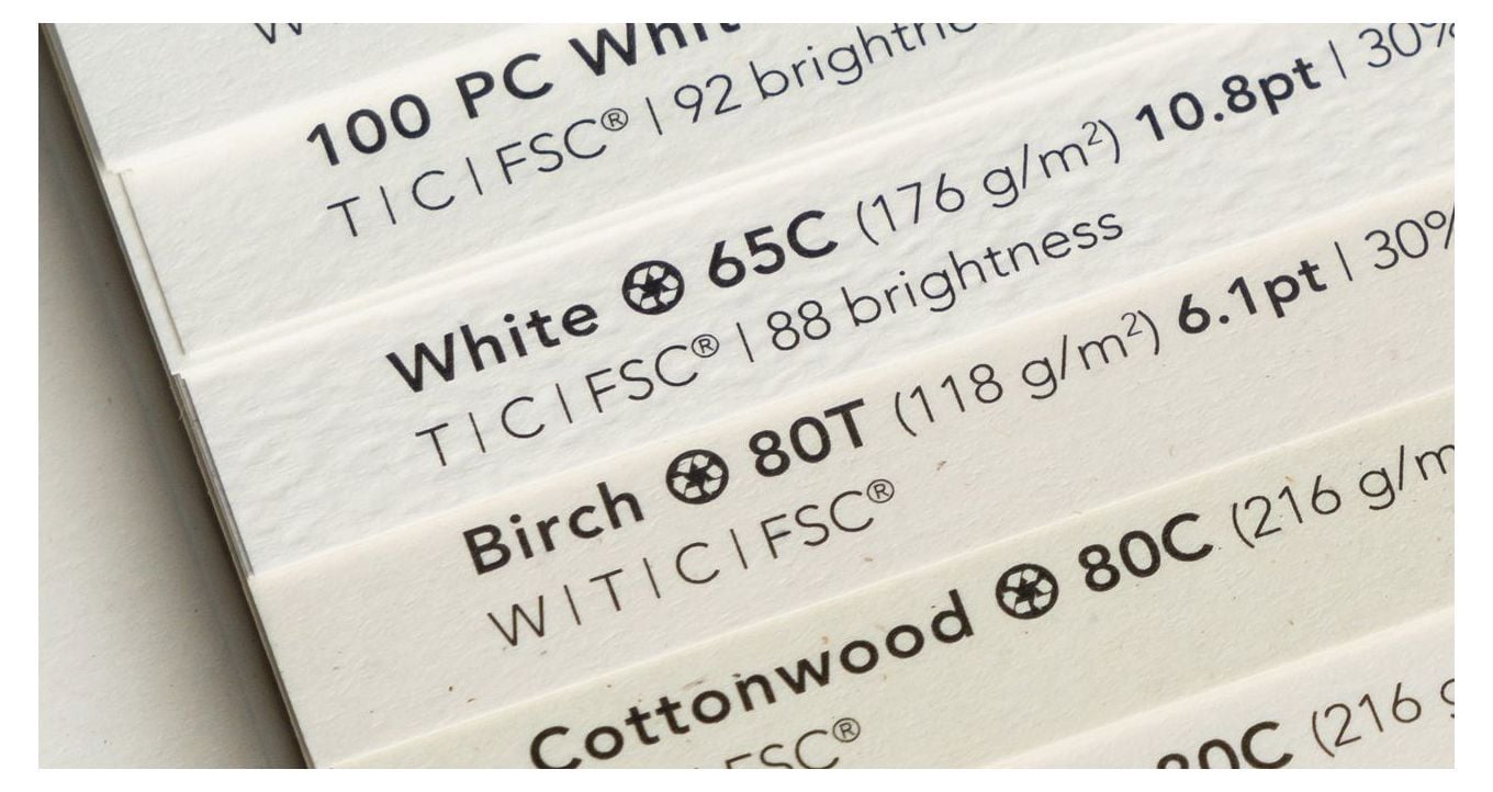 Image illustrating how to choose the right paper for your printing project showing closeup of one page of paper sample book.