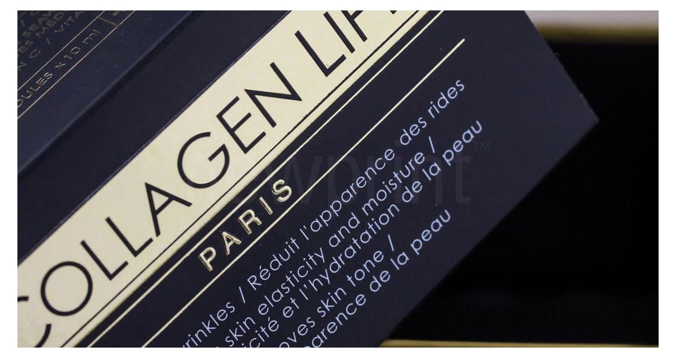 Close-up of a luxury packaging design, showing gold foil details on a black background,
