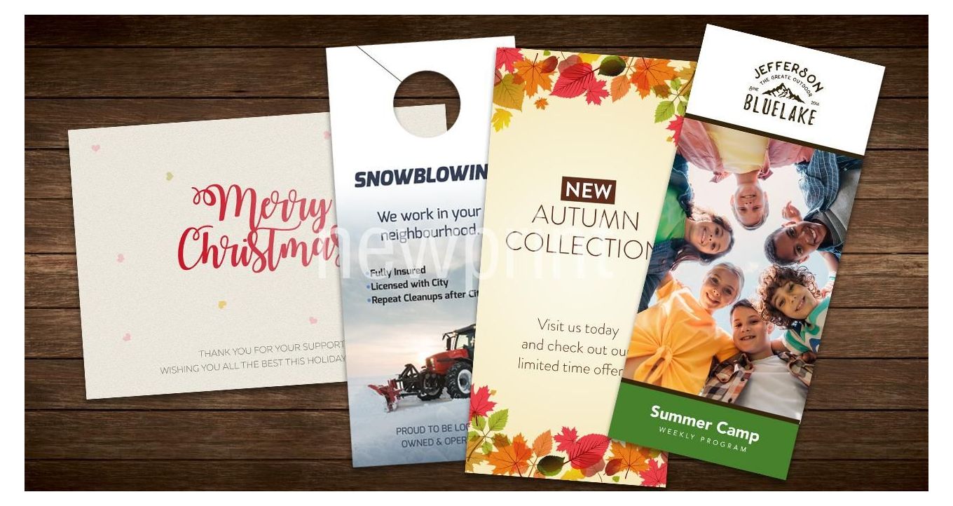 Seasonal marketing ideas - greeting card, door hanger, flyer and a brochure on a wooden surface.