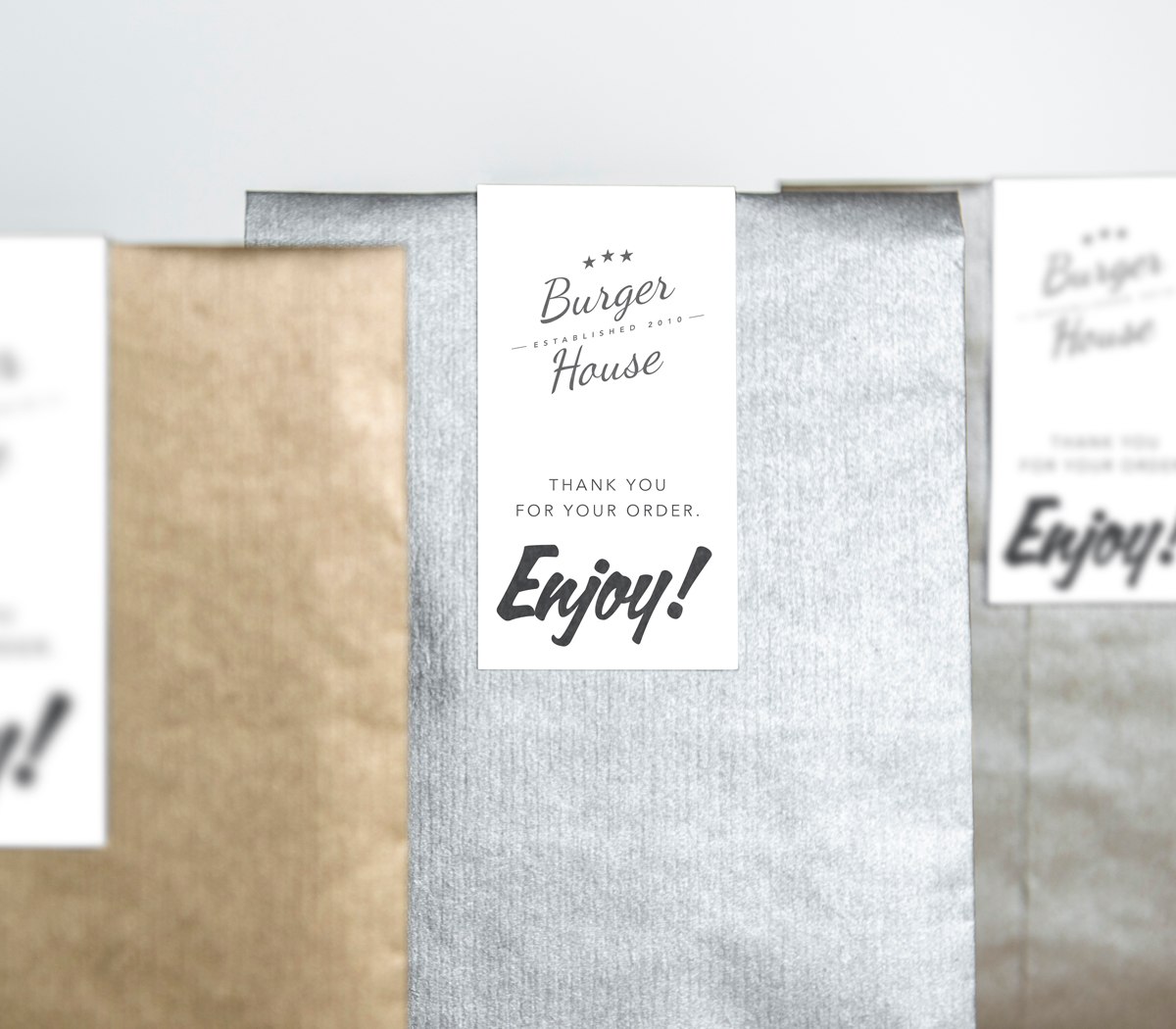 Different paper Cut Sheet Labels on the takeout bags as an example of branding.