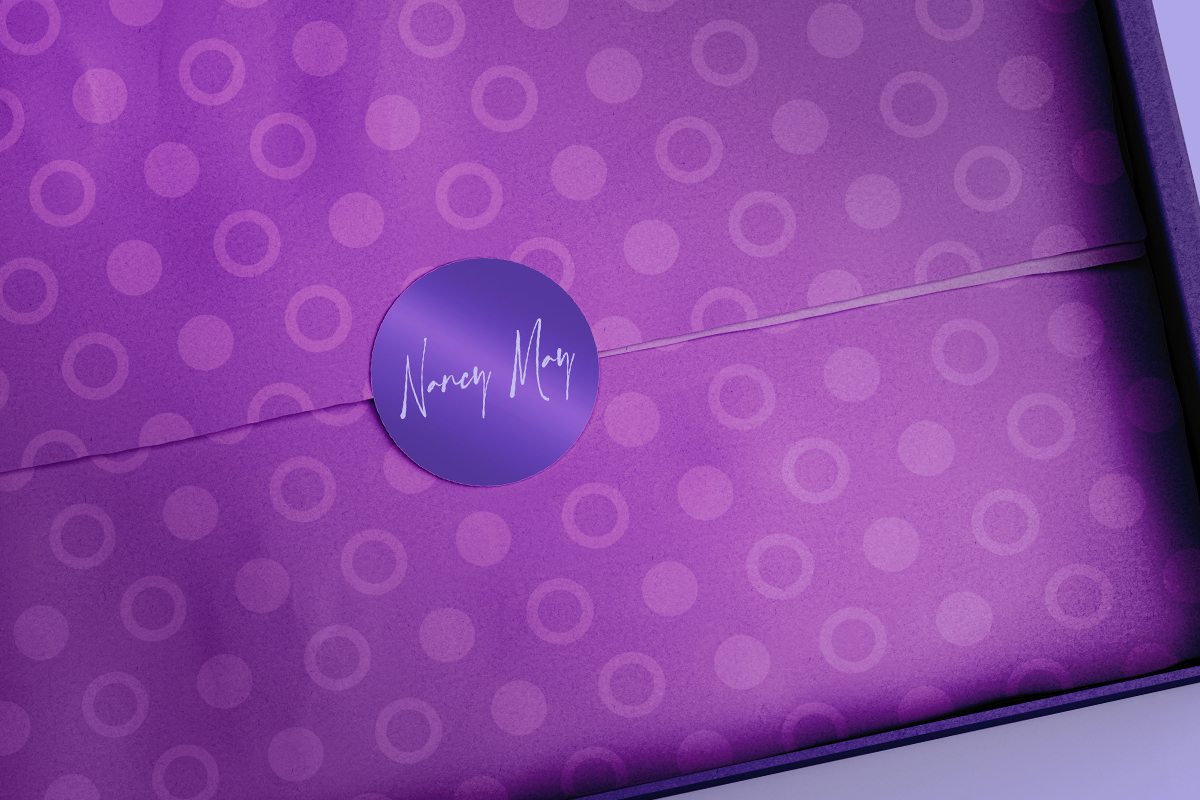 Repositionable vinyl Die Cut Label on the purple wrapping paper.