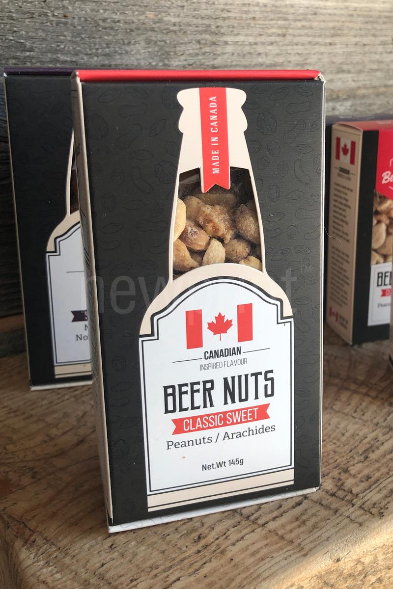 Front view of a mixed nuts custom food packaging box on a wooden background.