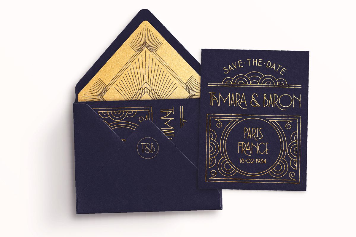 Example of graphic design trends – very elegant art deco style midnight blue invitation with gold details and matching envelope