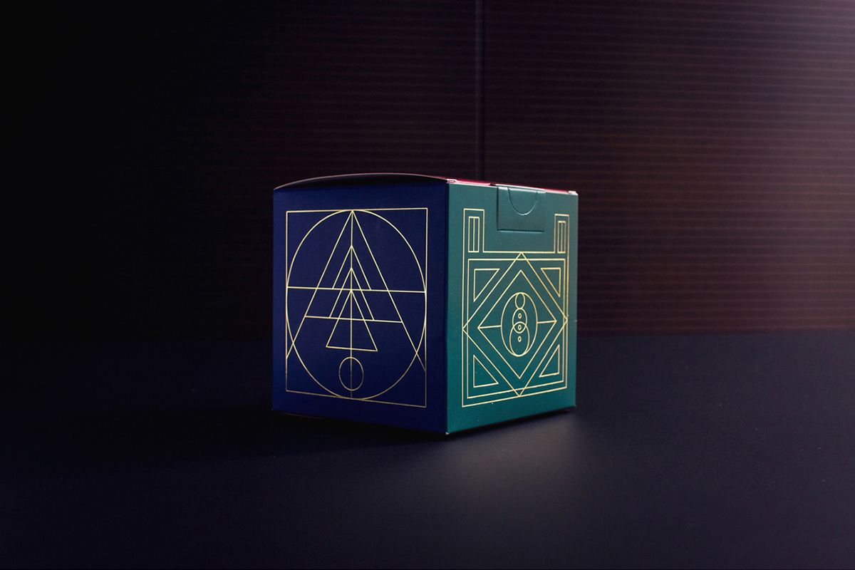 Example of graphic design trends –art deco style dark green packaging box with golden details