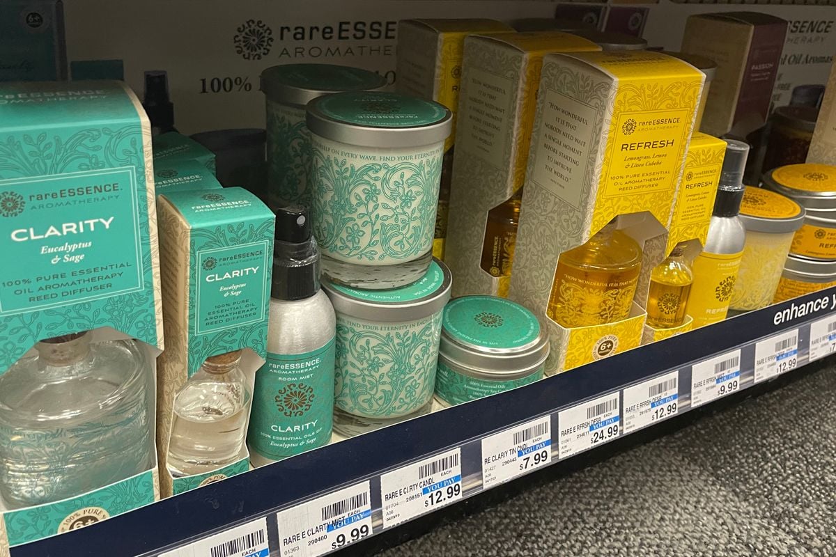 A stack of cosmetic products with cosmetic packaging visible on the store shelf.
