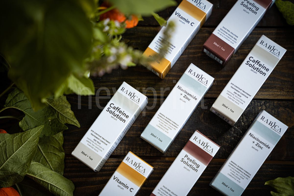 Different custom eco-friendly packaging boxes for serums on the flat surface