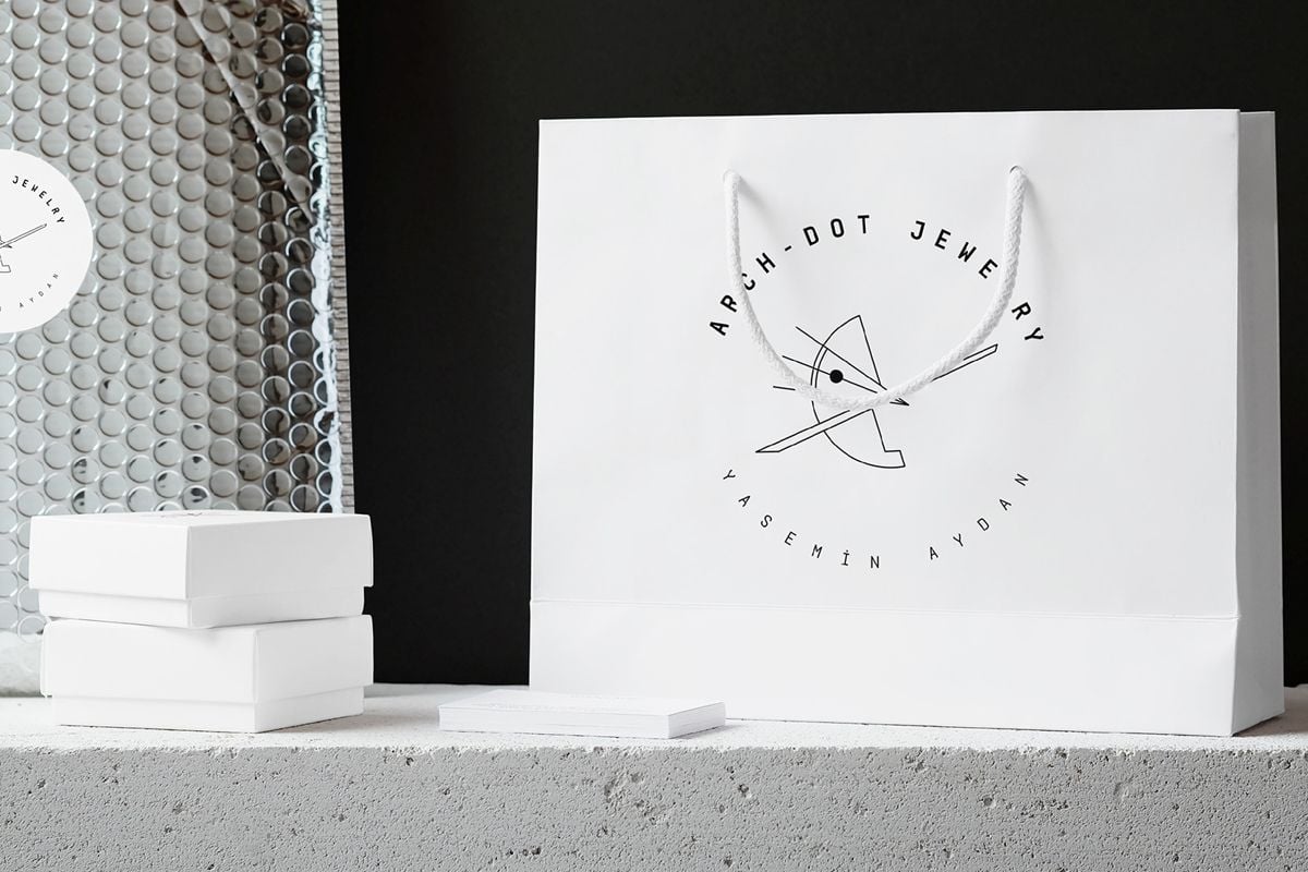 Jewelry Packaging Ideas-Two white jewelry packaging boxes and white bag with the logo