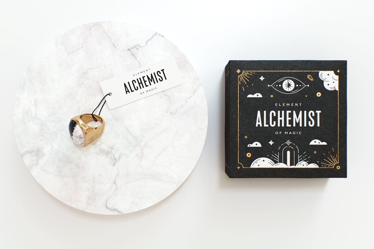 Jewelry Packaging Ideas-Black alchemy themed custom jewelry box packaging with one golden ring next to it