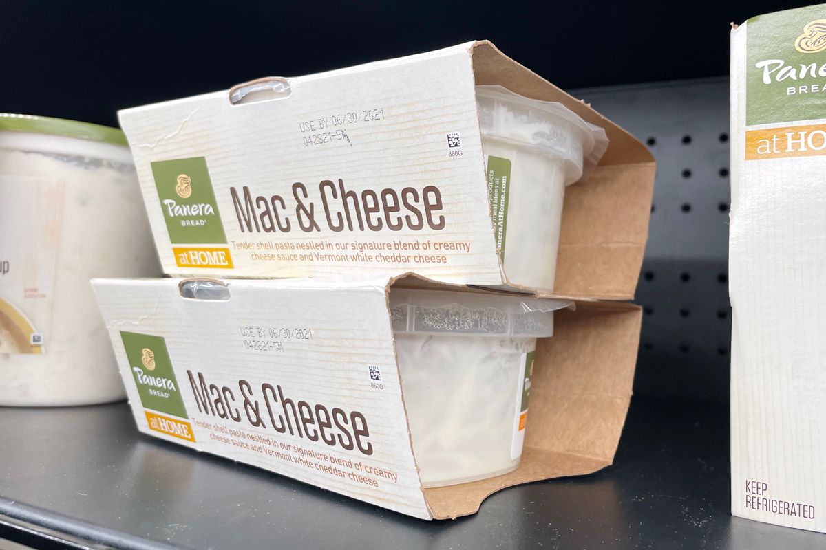 Food Packaging Sleeves-Two Mac and Cheese Food Container Jars in Printed Food Packaging Sleeves on a Store Shelf