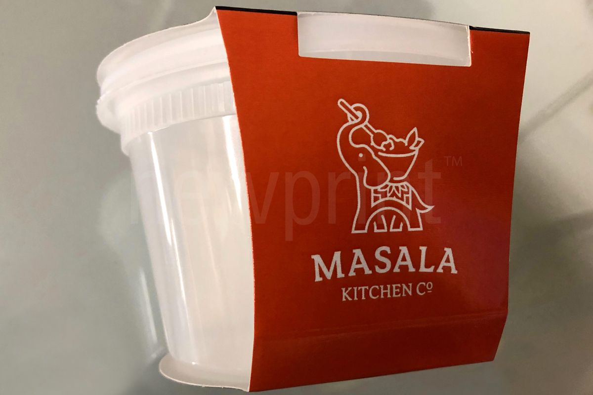 Food Packaging Sleeves-Empty Plastic Food Container With a Printed Food Packaging Sleeve Wrapped