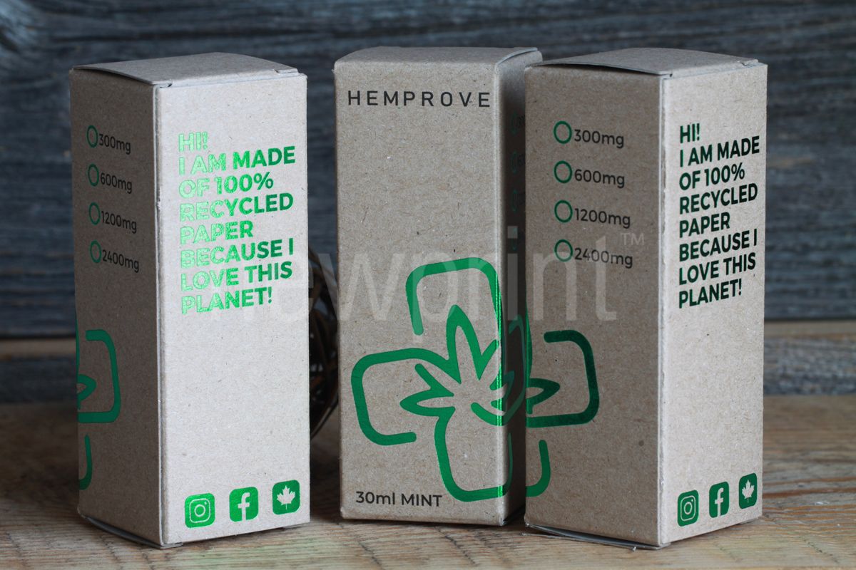 Three small custom luxury boxes made of kraft paper, with green foil details and black text printed on them.