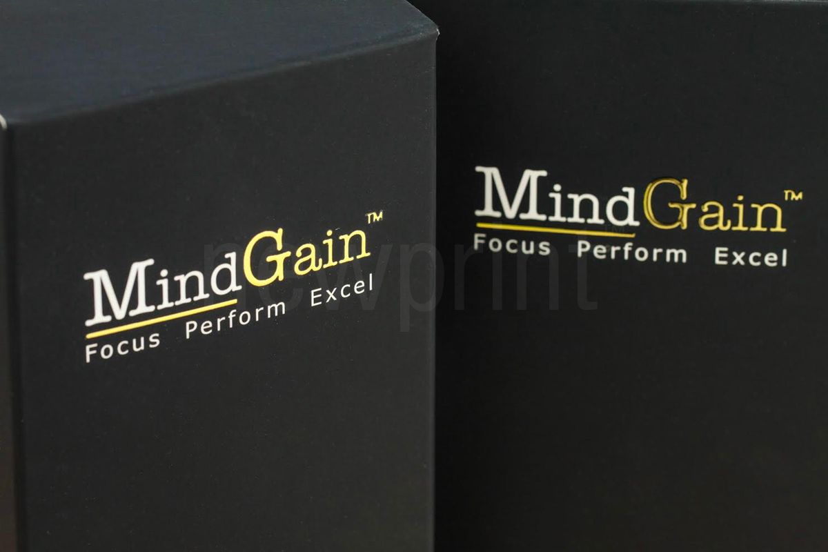 Gold foil logo printed on a black luxury packaging box.