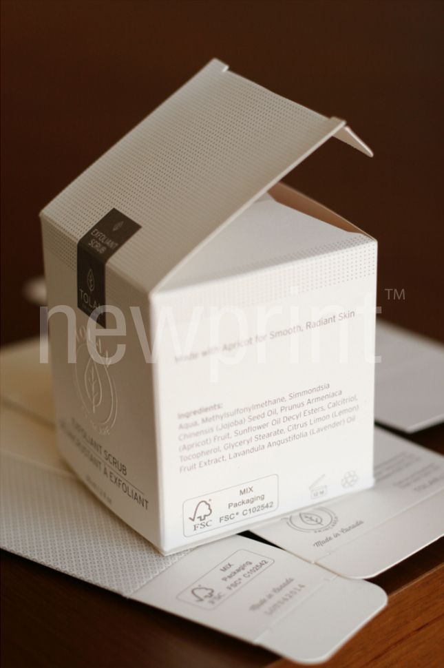 Cube-shaped luxury packaging for cosmetic product with an emboss detail.