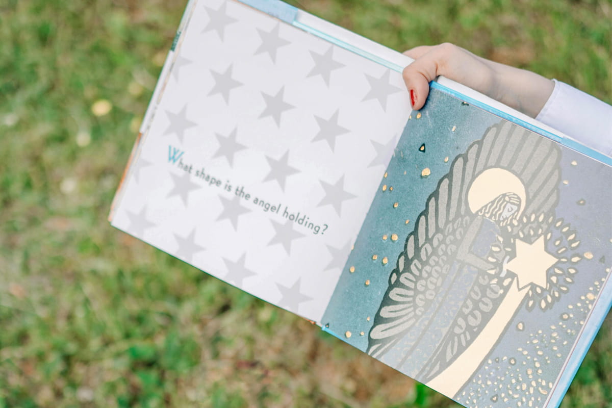 Woman holding colorful printed book