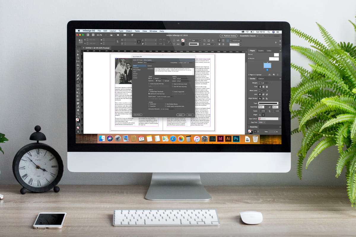 A computer screen displays work in InDesign software as a book design is being prepared for printing.