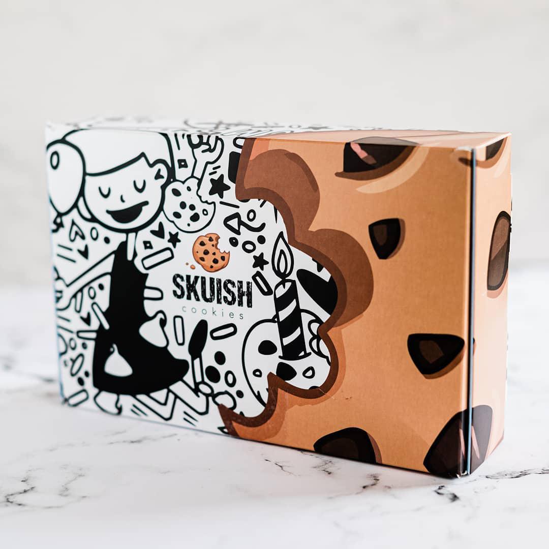 custom cookie box packaging with cartoonish design and brown cookie-like part