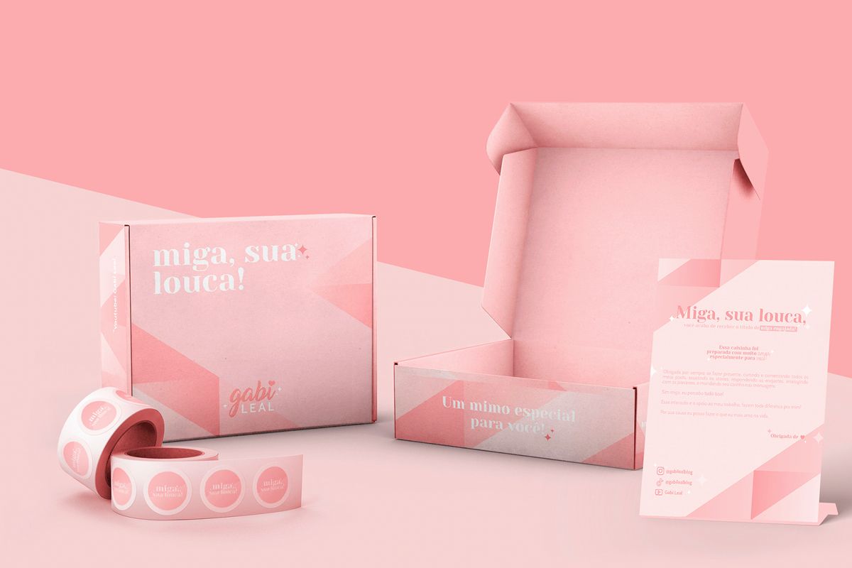 Open and closed pink packaging with elements of the ultimate unboxing experience next to it