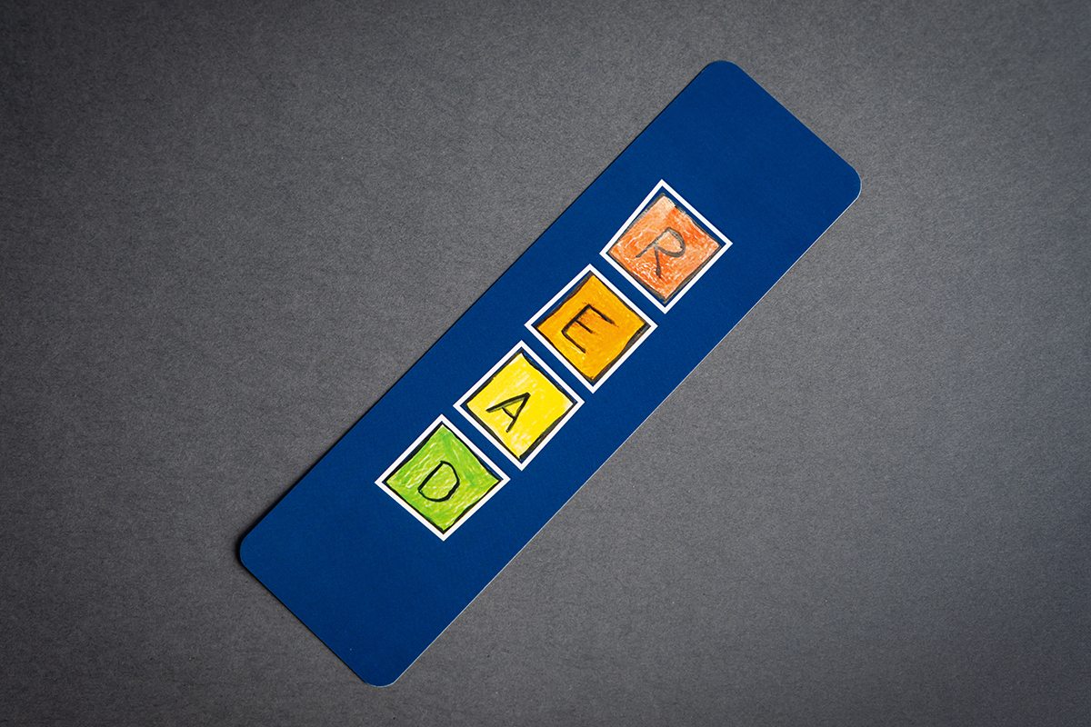 Image showing dark blue Bookmarker with colorful letter design.