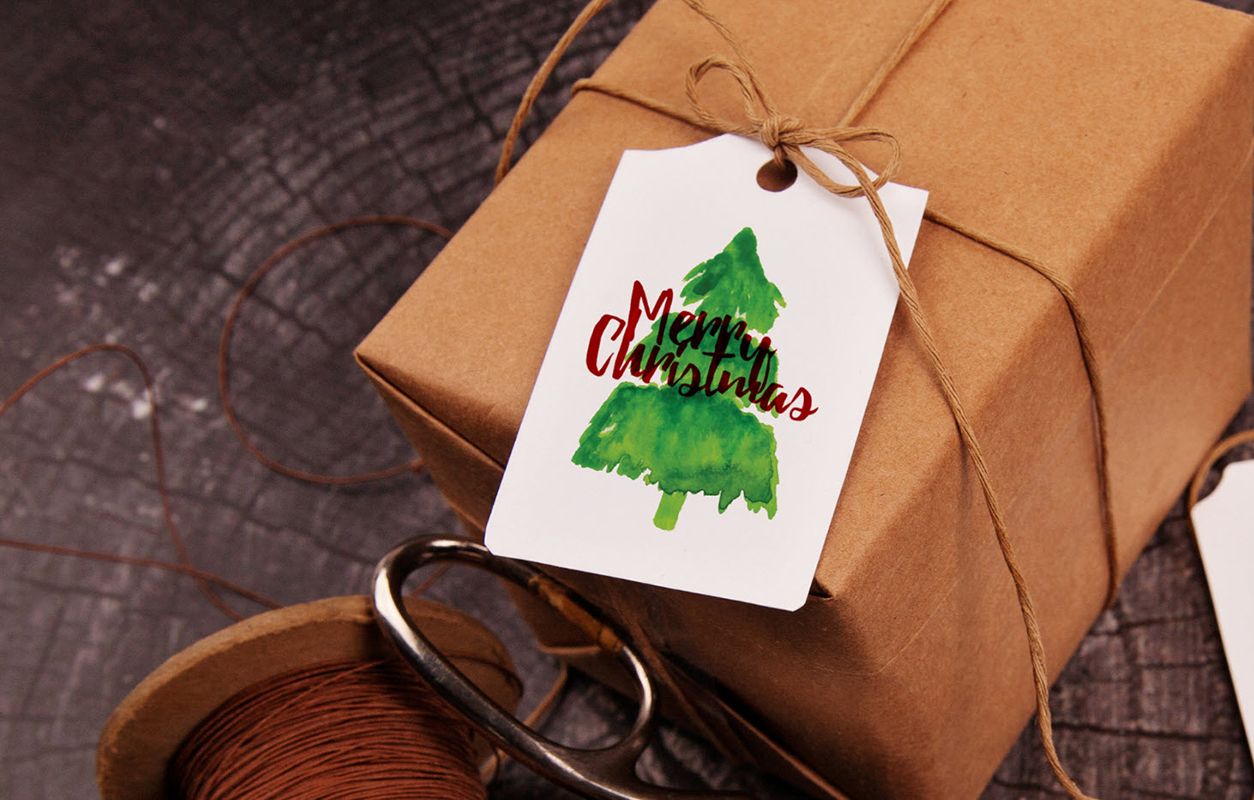 Christmas packaging design inspiration, wrapped box with a Christmas tag attached.