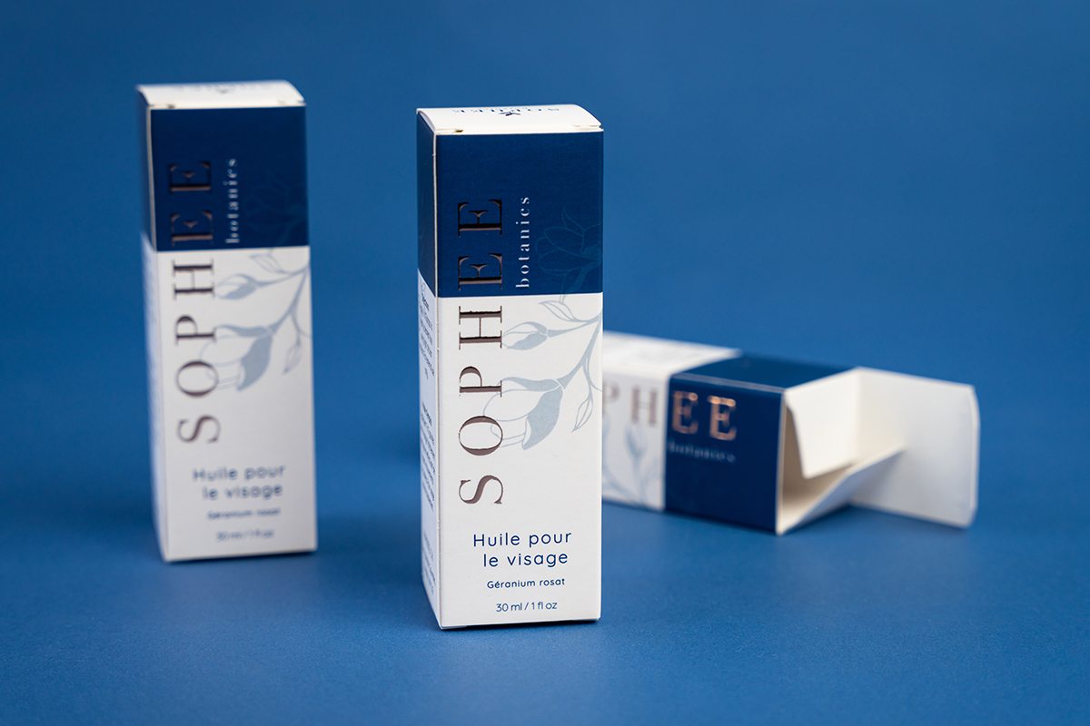 Three elegant blue and white boxes with metallic foil that illustrate custom packaging options.