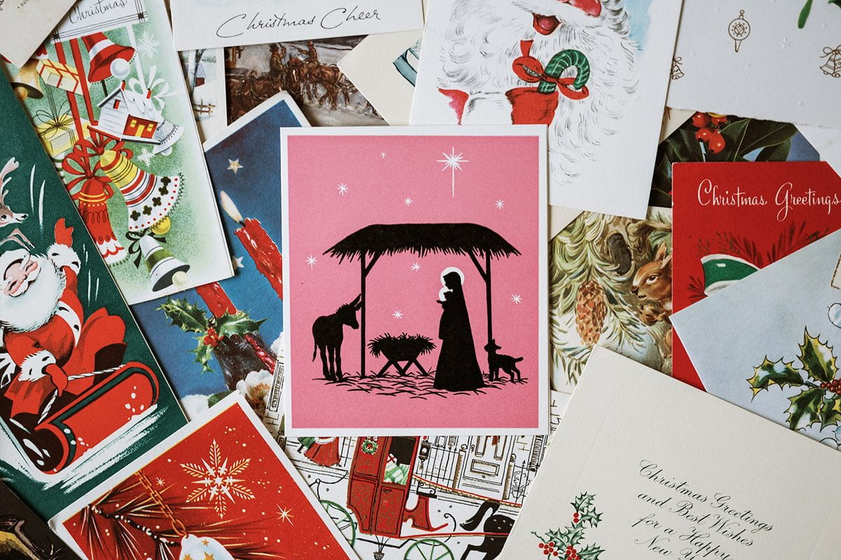 Postcards of various designs and sizes spread on a table.