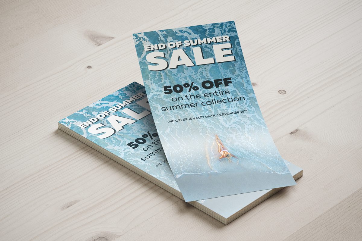 Image showing stack of flyers announcing summer sale on wooden surface.