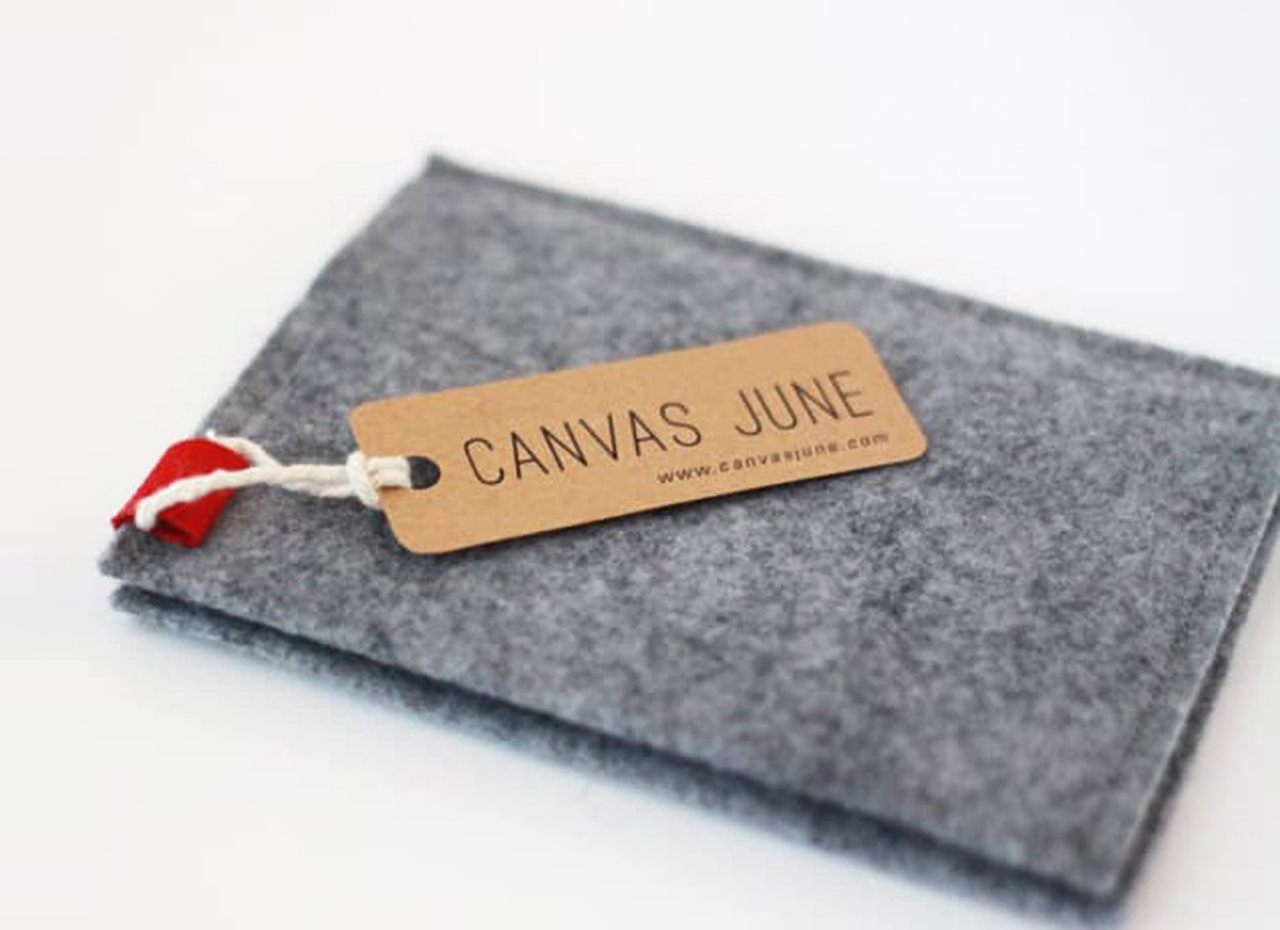 Simple hang tag example for wallet with just brand name on kraft paperboard.