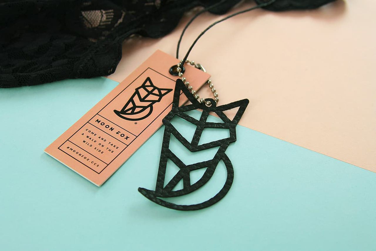 Combination of simple kraft paperboard hang tag and custom shaped fox as one of the hang tag examples.