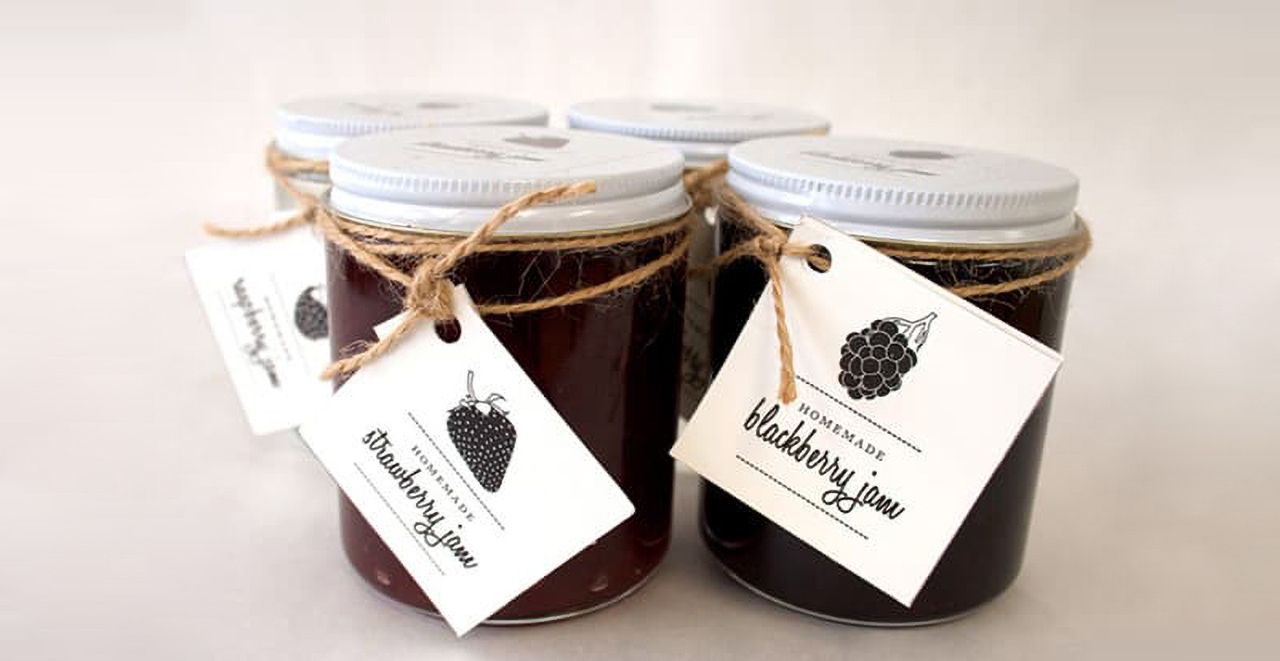 Simple hang tag examples with black fruit and the name of the jam on the white background. 