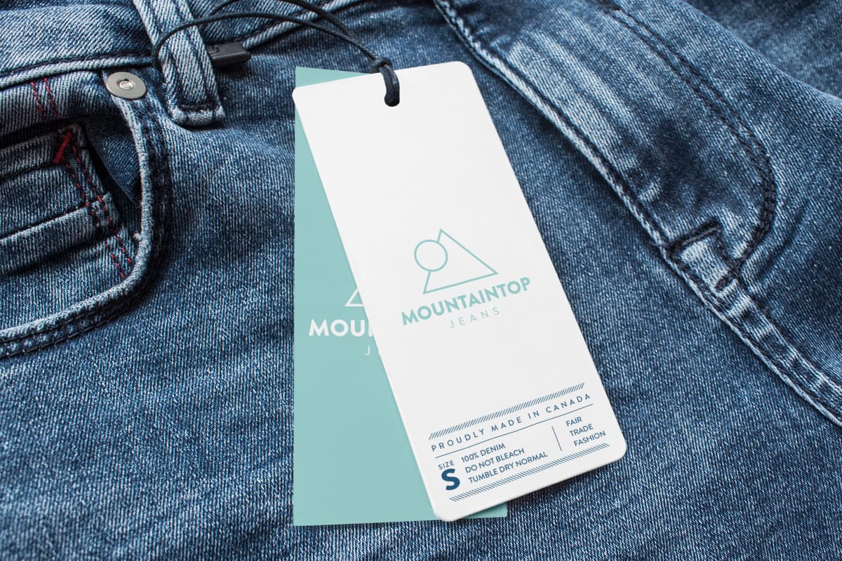 Image showing hang tags, turqoise and white, attached to jeans as an example for hang tags printing.