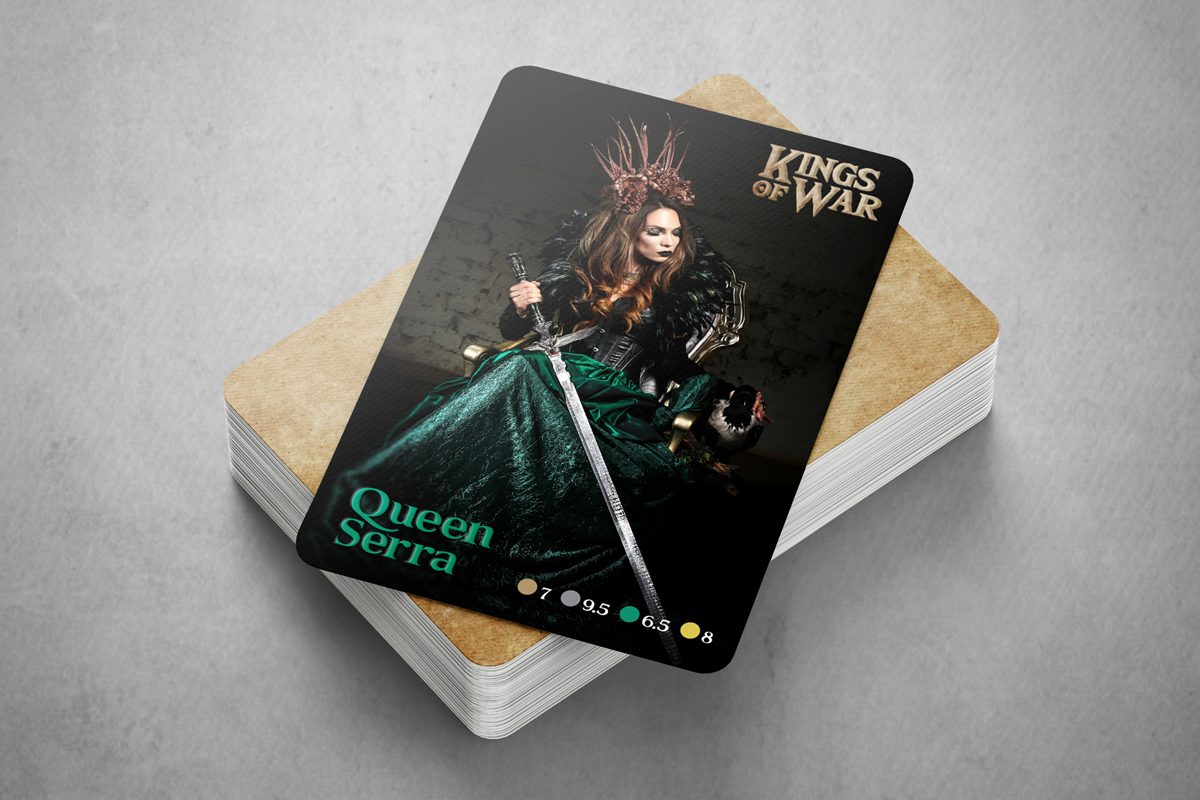 A gaming deck of trading cards with the top card showing a woman on the throne, holding a sword.