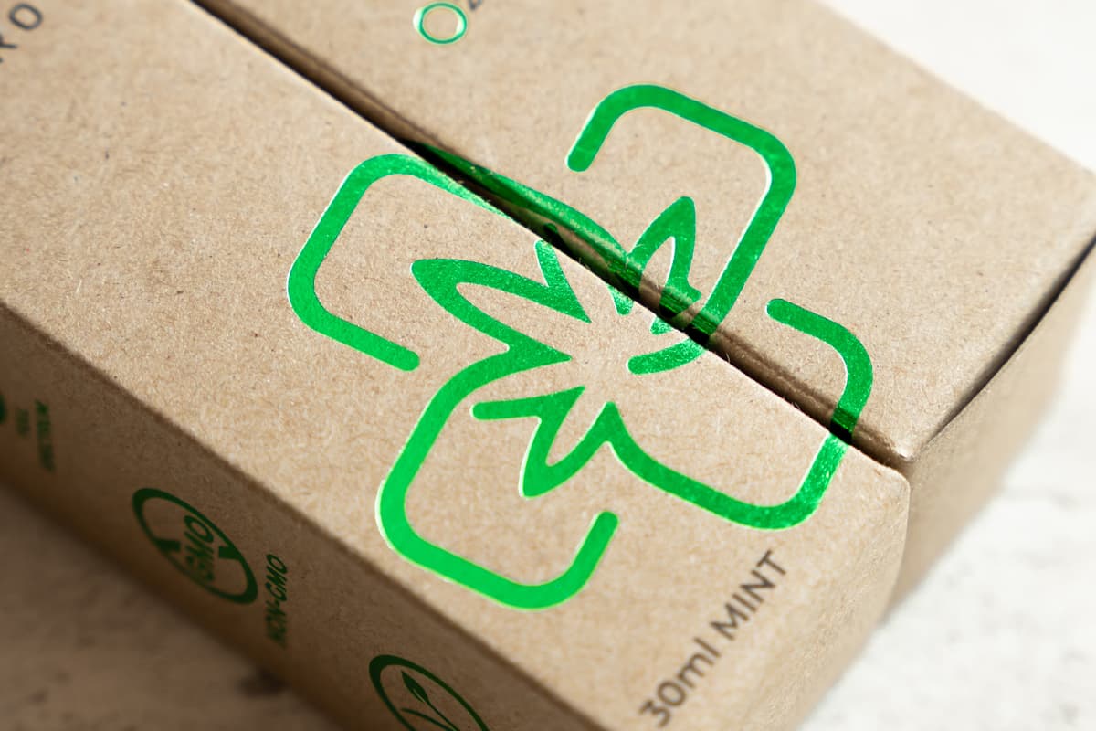 Image showing two Straight Tuck End Boxes made of kraft paper with green foil next to ecah other.