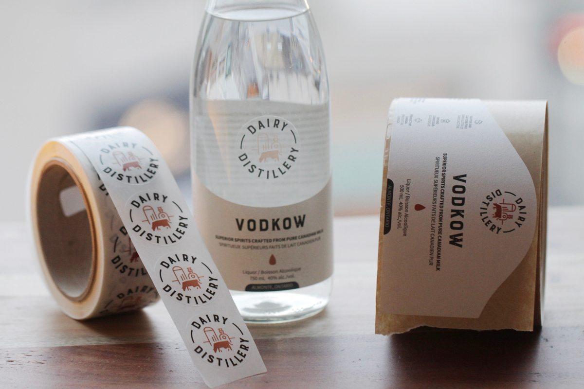 Types of packaging products -  glass bottle with labels next to it.