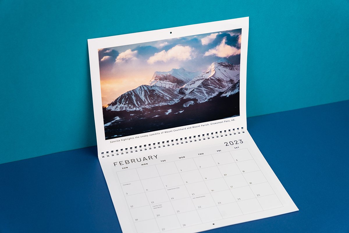 Image showing an opened Wall Calendar on blue background.